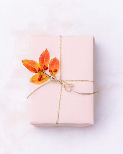 Gift wrapped with leaves and red berries